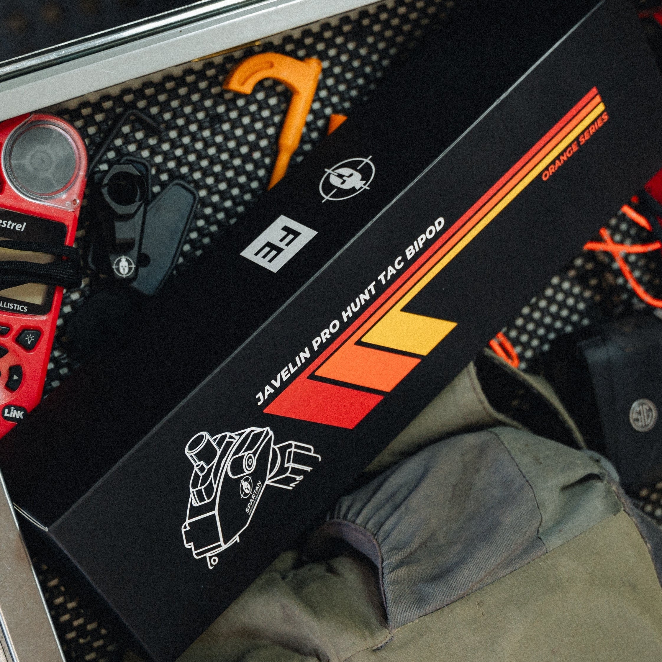 Open drawer with tools and equipment on a wooden surface
